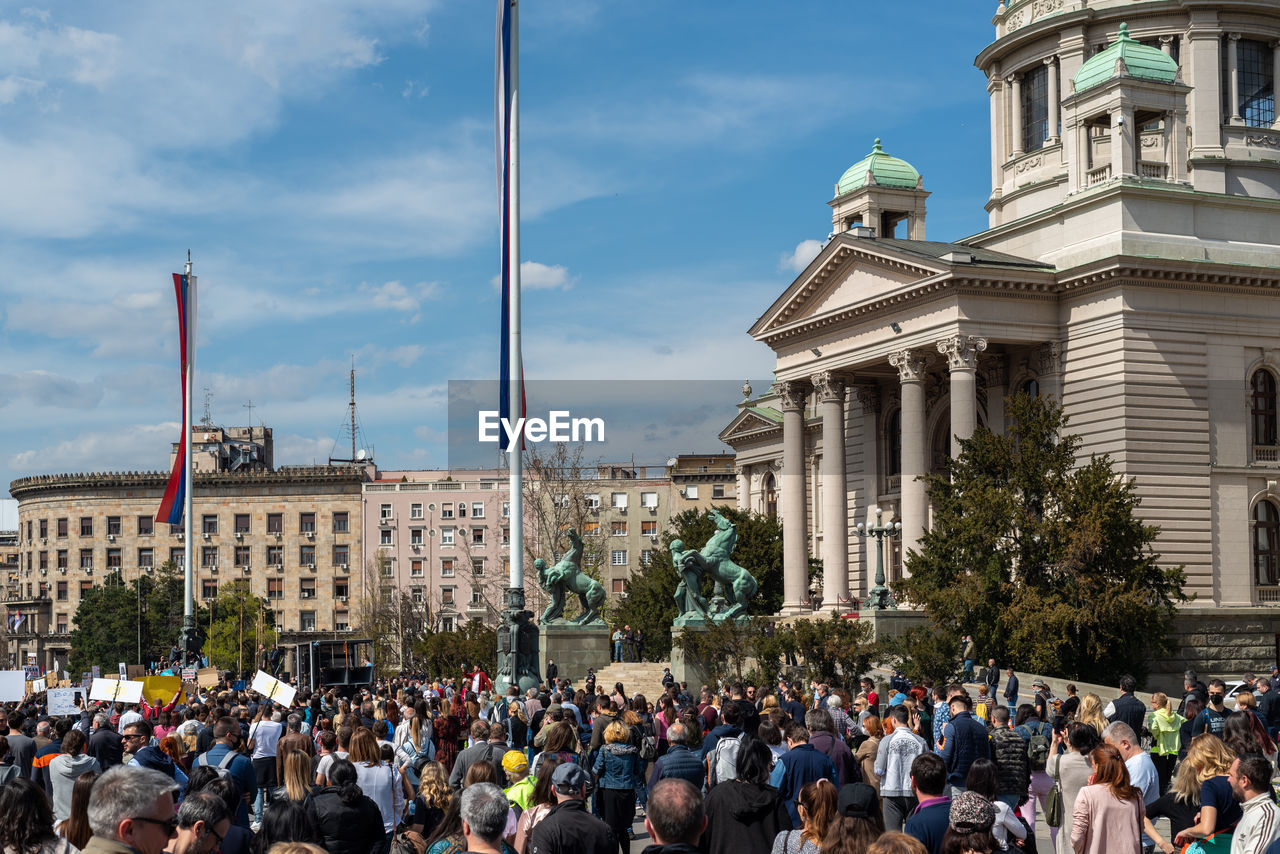 Group of people in front of buildings in city