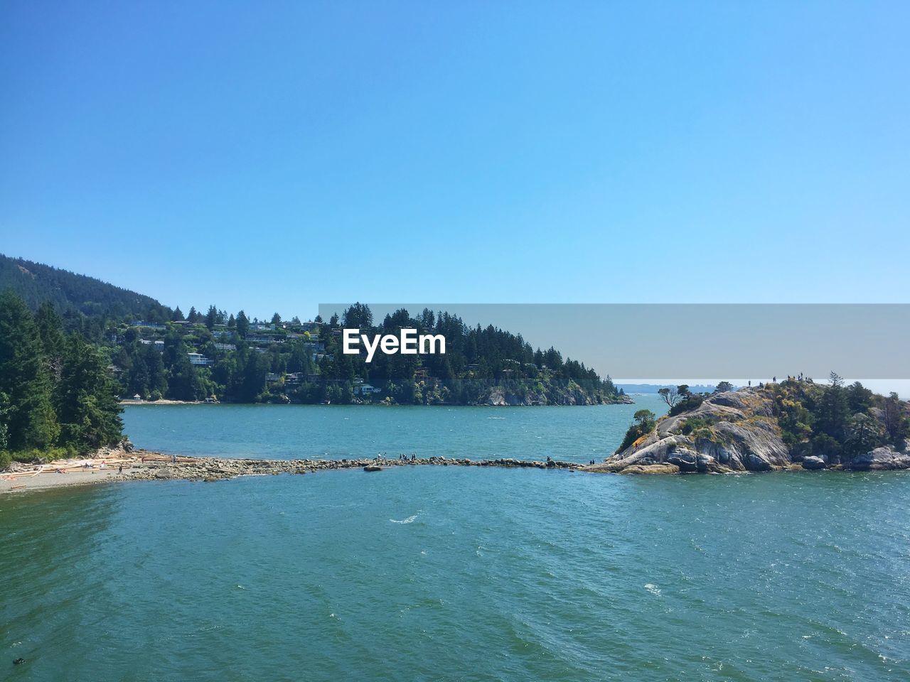 Scenic view of sea against clear blue sky