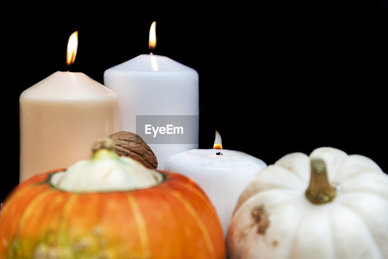 CLOSE-UP OF CANDLES ON WHITE