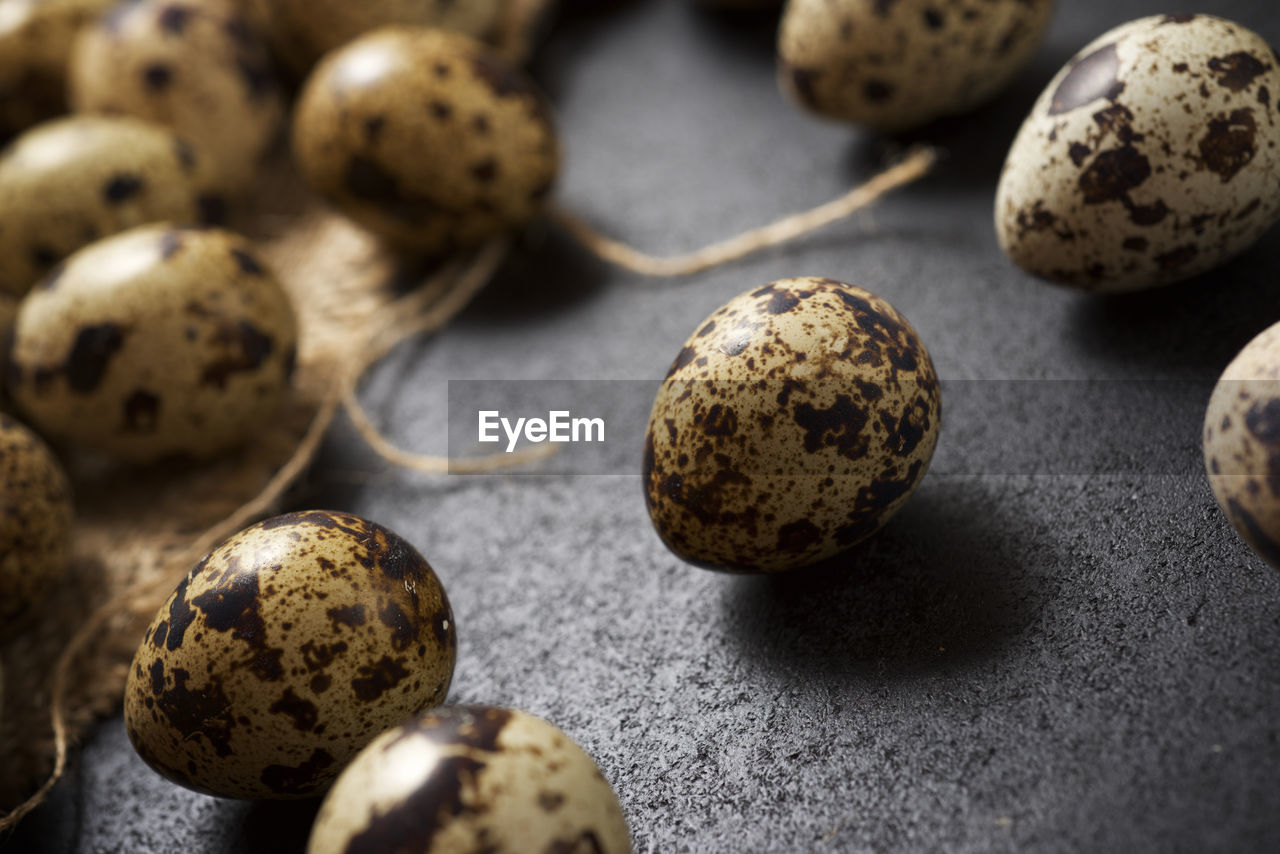 Quail eggs on a black table.