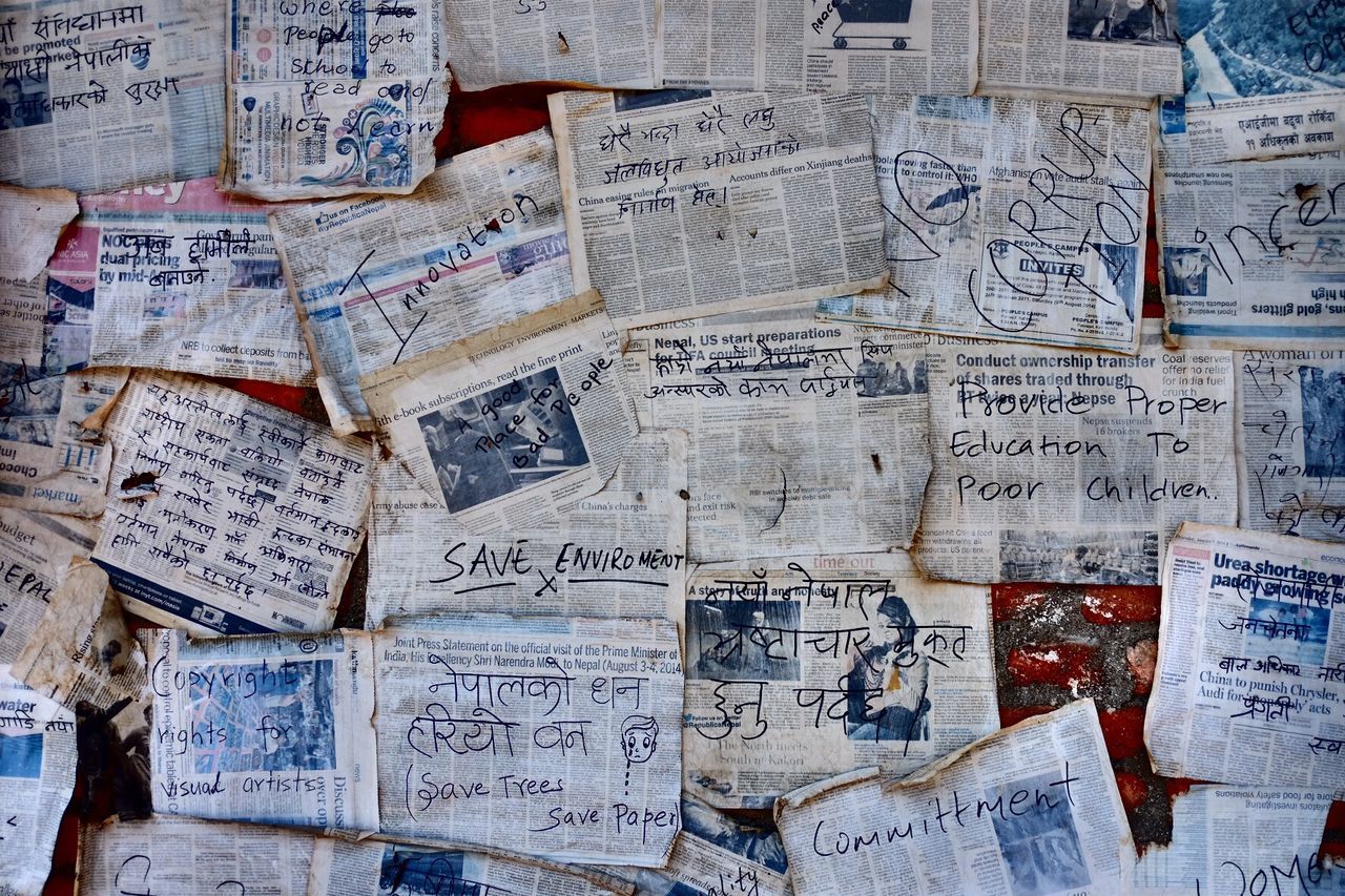 Full frame shot of old newspaper stuck on wall