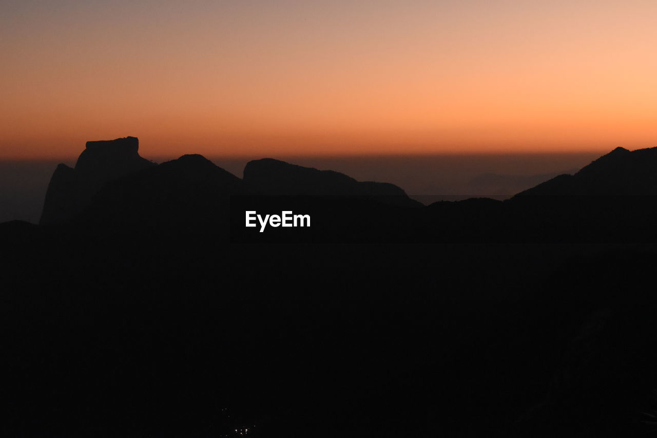 SCENIC VIEW OF SILHOUETTE MOUNTAINS AGAINST SKY DURING SUNSET