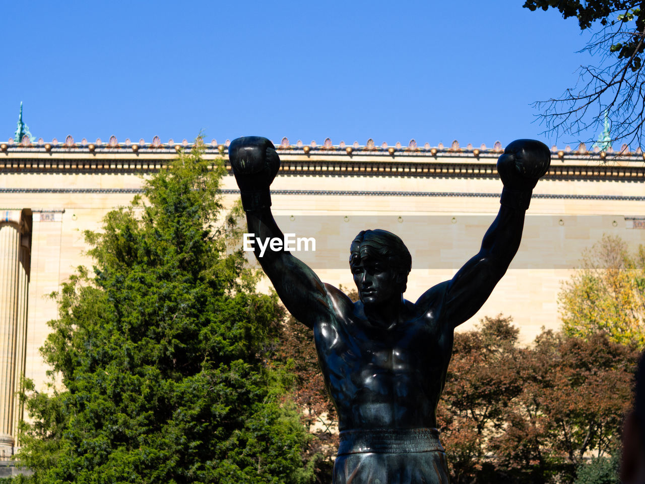 STATUE AGAINST TREES AND PLANTS