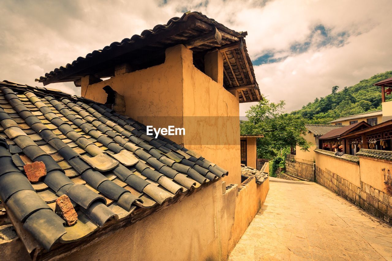 VIEW OF HOUSES AGAINST CLOUDY SKY