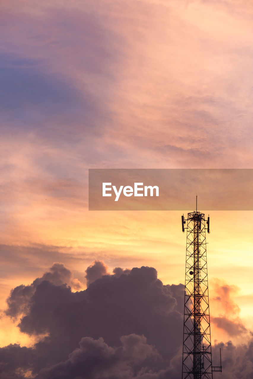 low angle view of electricity pylon against cloudy sky during sunset