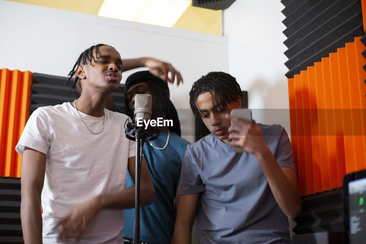 Teenage rappers recording song in studio