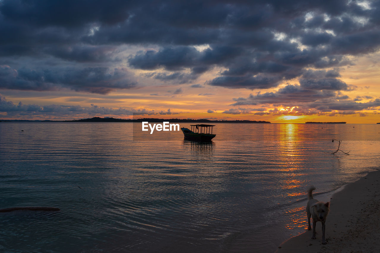 SCENIC VIEW OF SEA AGAINST ORANGE SKY