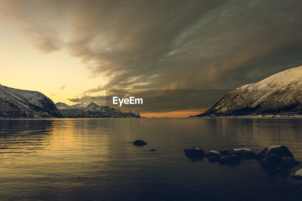 Scenic view of lake against sky during sunset