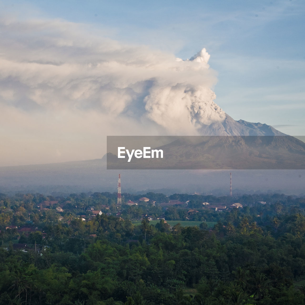 Scenic view of volcano against cloudy sky