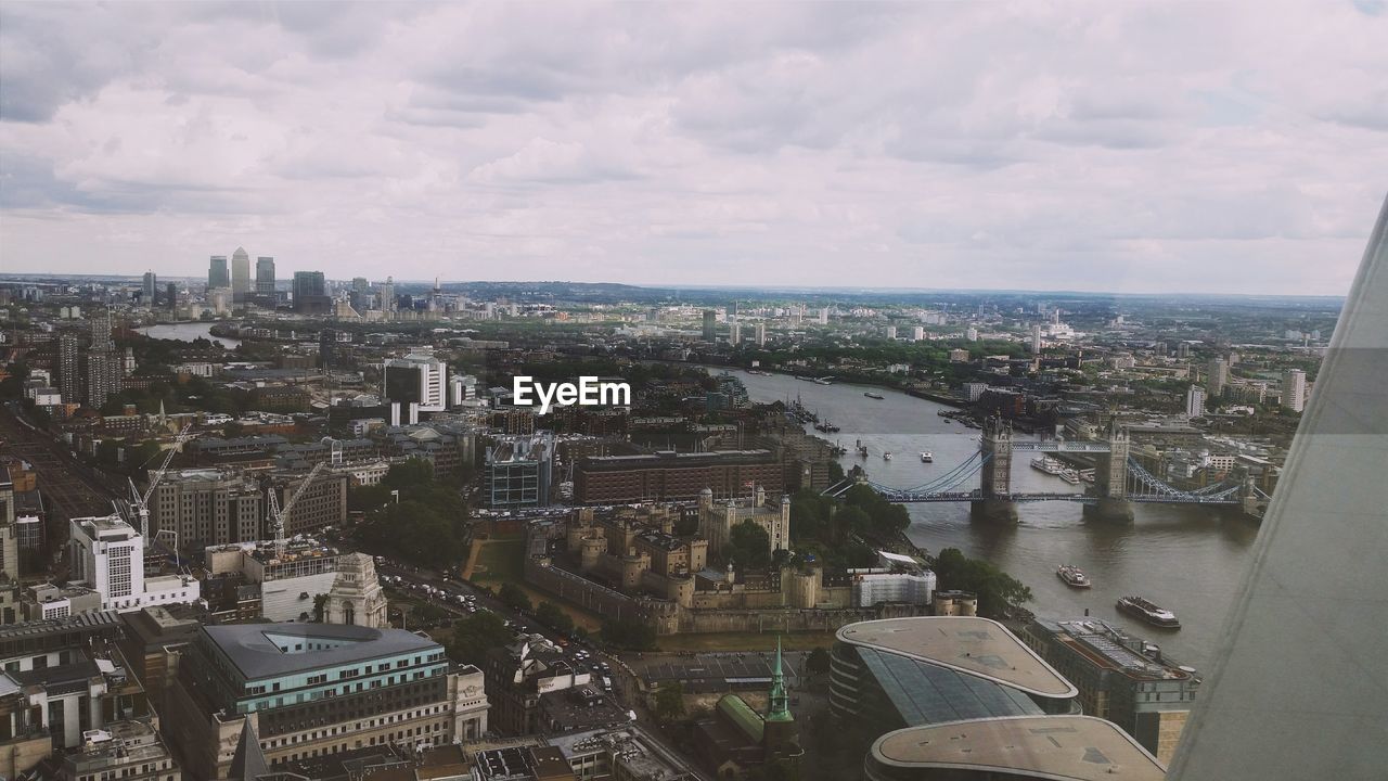 High angle view of cityscape against cloudy sky