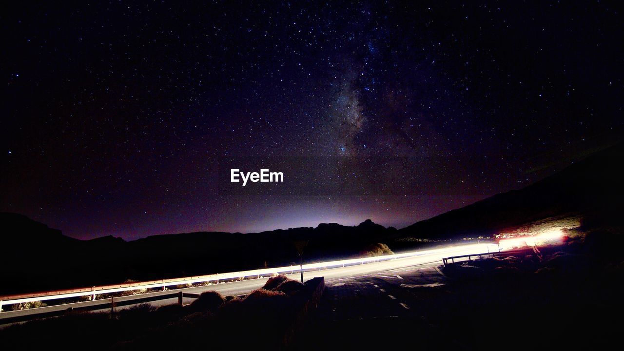 Scenic view of mountain against sky at night