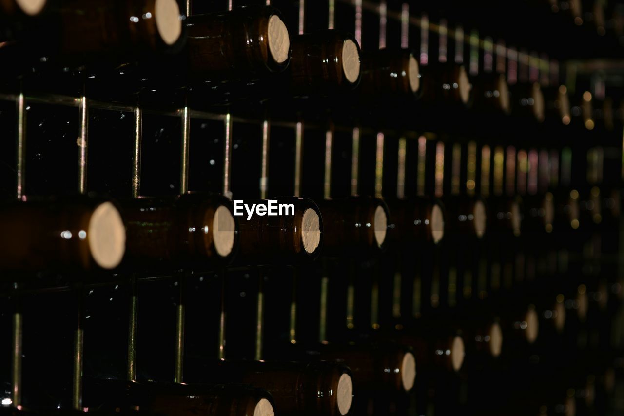 Close-up of wine bottles on stand