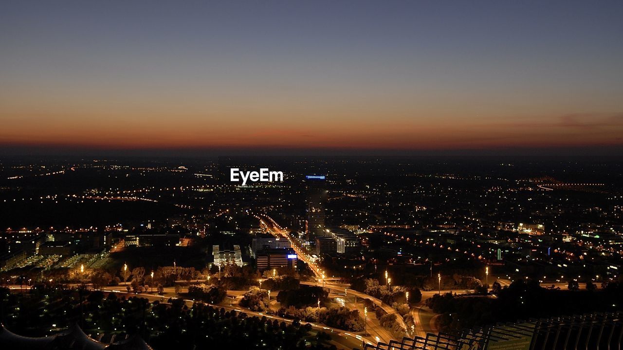 Aerial view of cityscape against sky at dusk