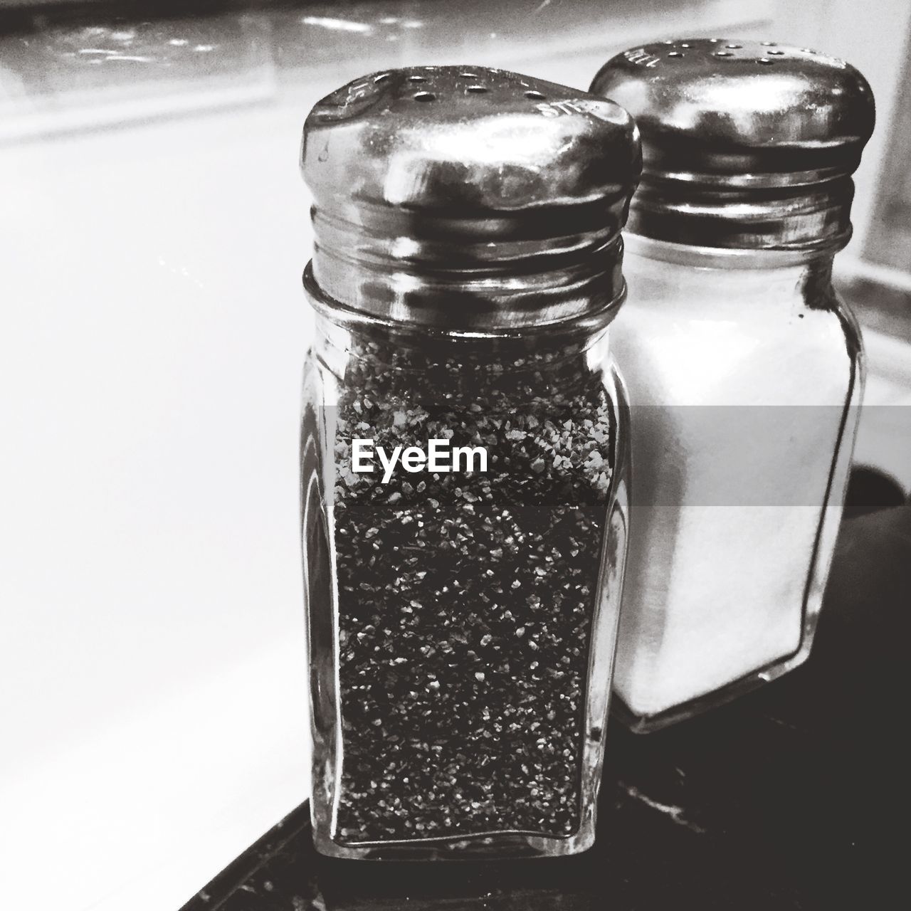 Close-up of salt and pepper shakers on table in restaurant