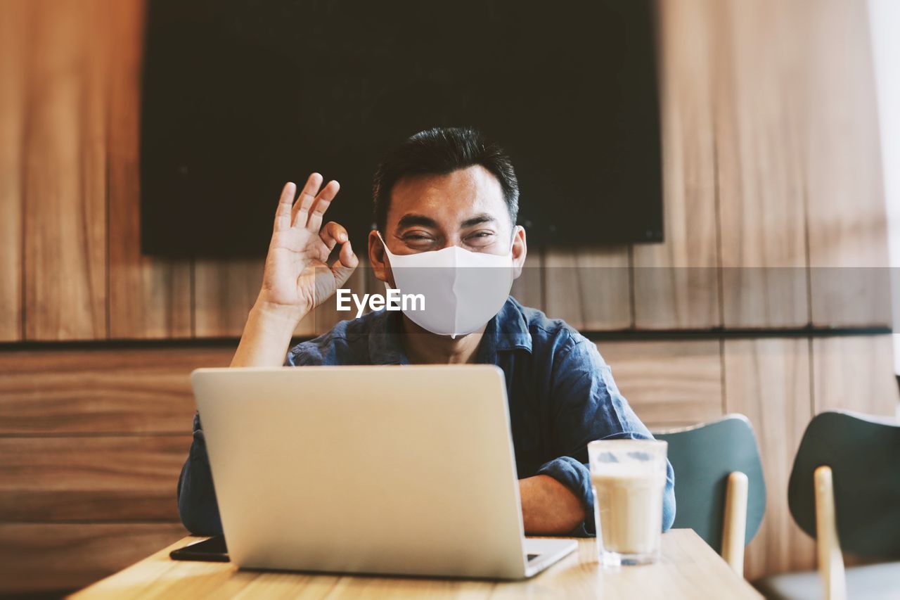 Mid adult man using laptop on table