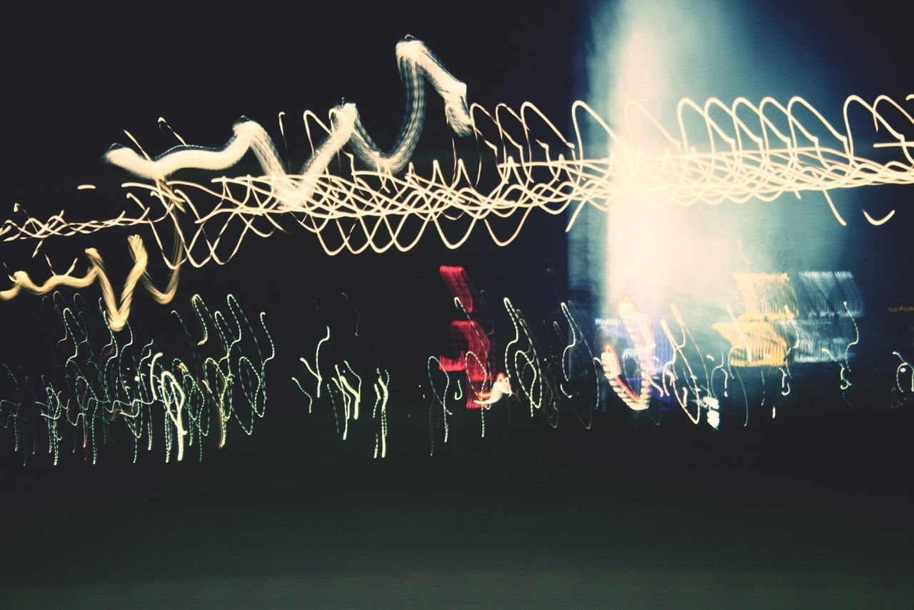 VIEW OF ILLUMINATED LIGHTS AT NIGHT