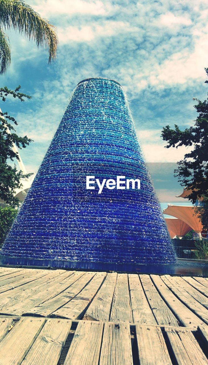 Pyramid shape fountain against sky in parque das nacoes
