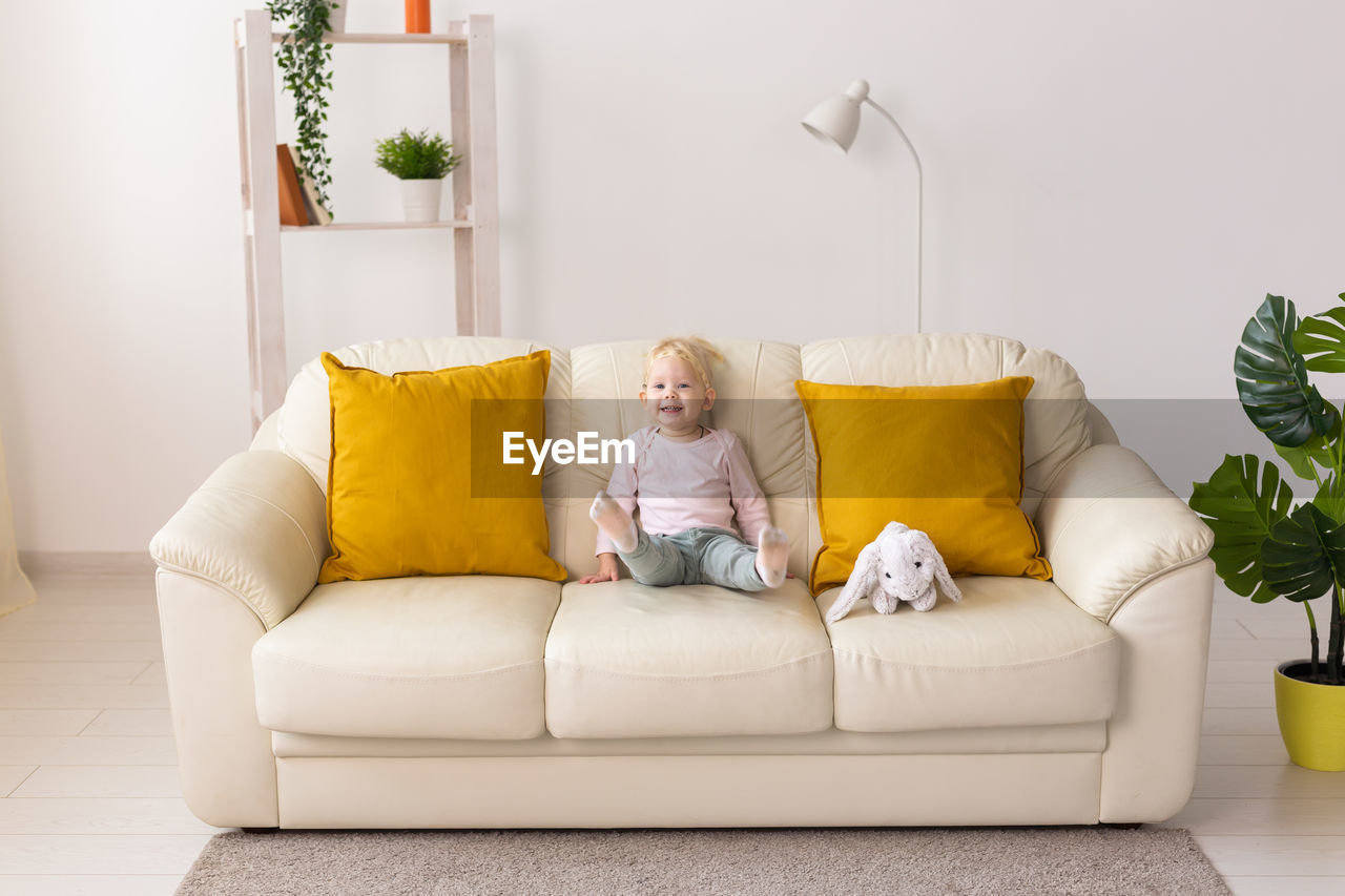 low section of woman using laptop at home