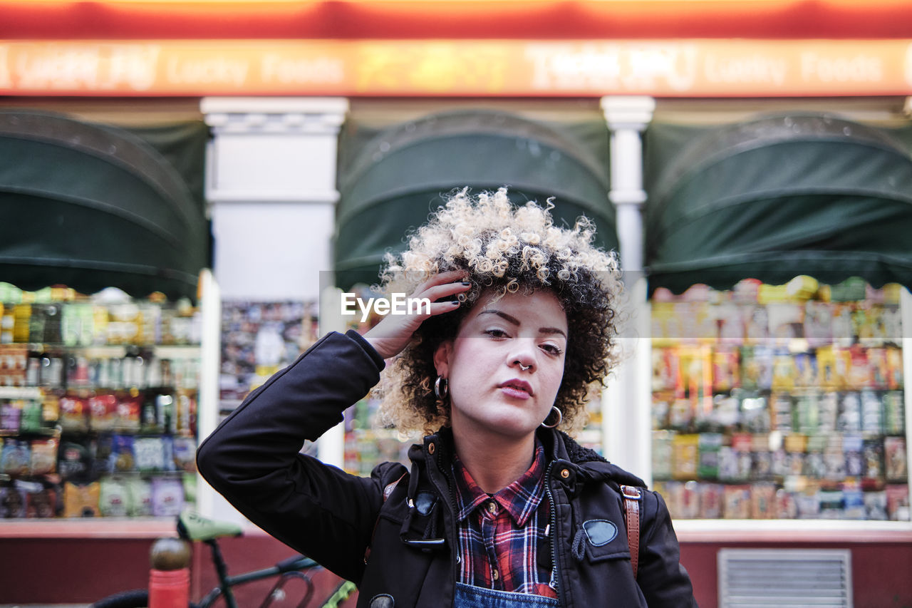 Hipster woman with hand in hair at chinatown