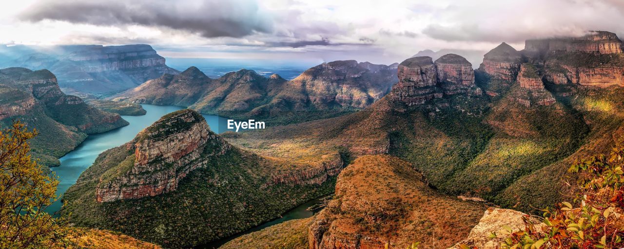 Panoramic view of mountains against cloudy sky