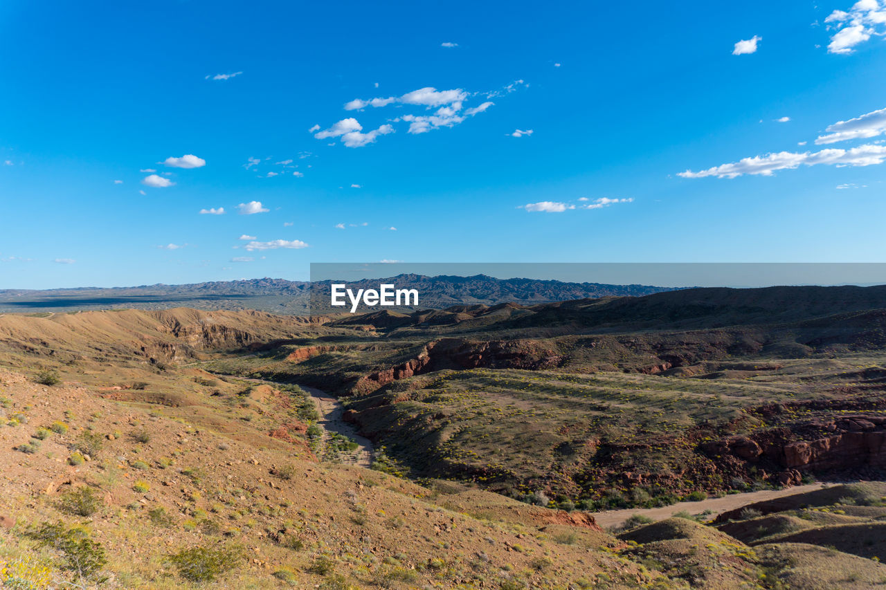 Scenic view of mountains against blue sky