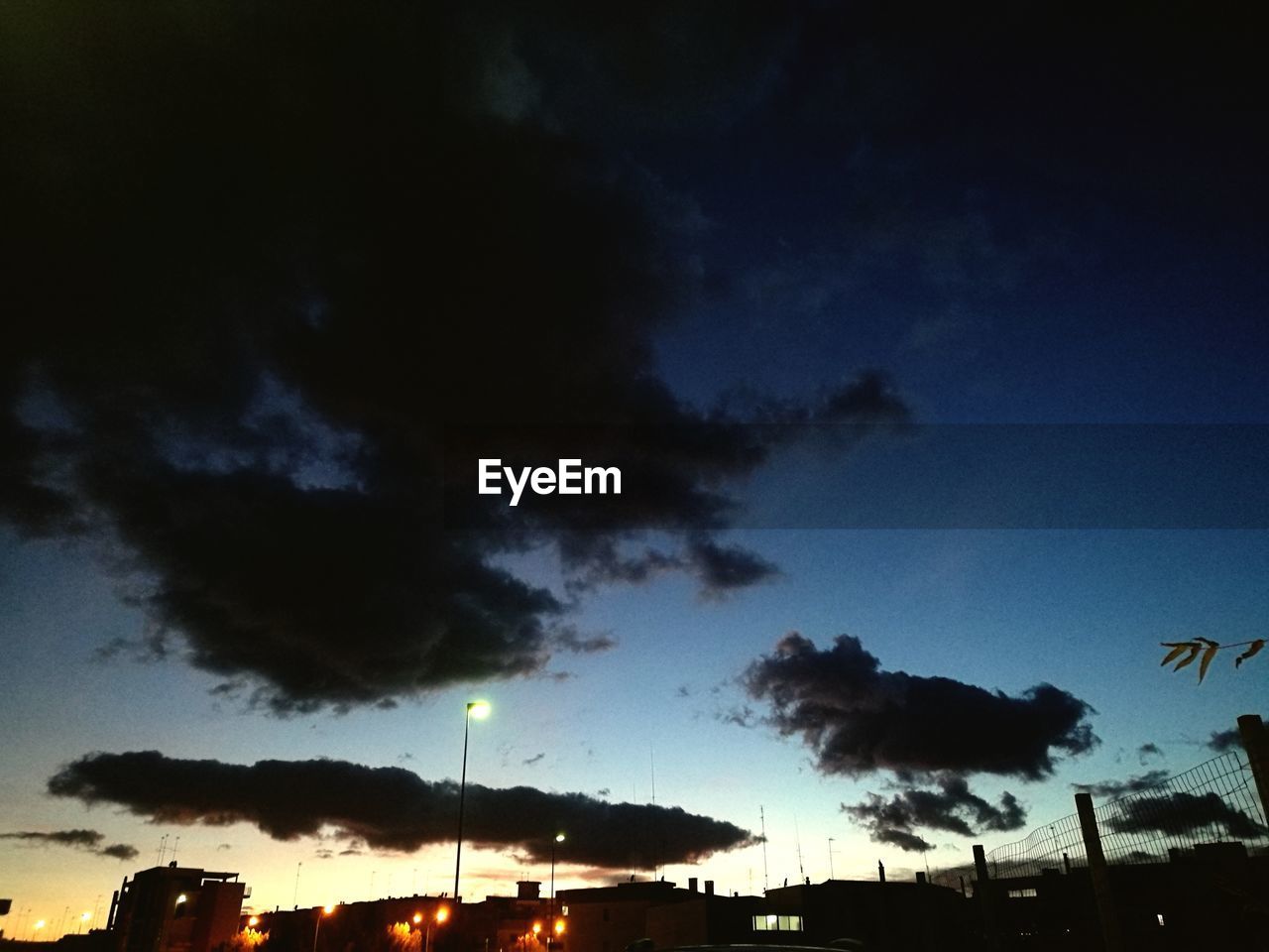 LOW ANGLE VIEW OF SILHOUETTE TREES AGAINST BLUE SKY
