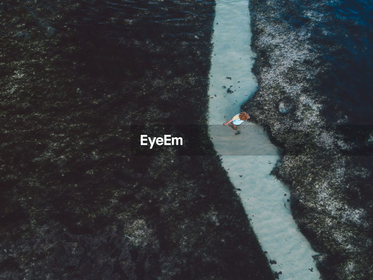 Aerial view of woman standing at beach