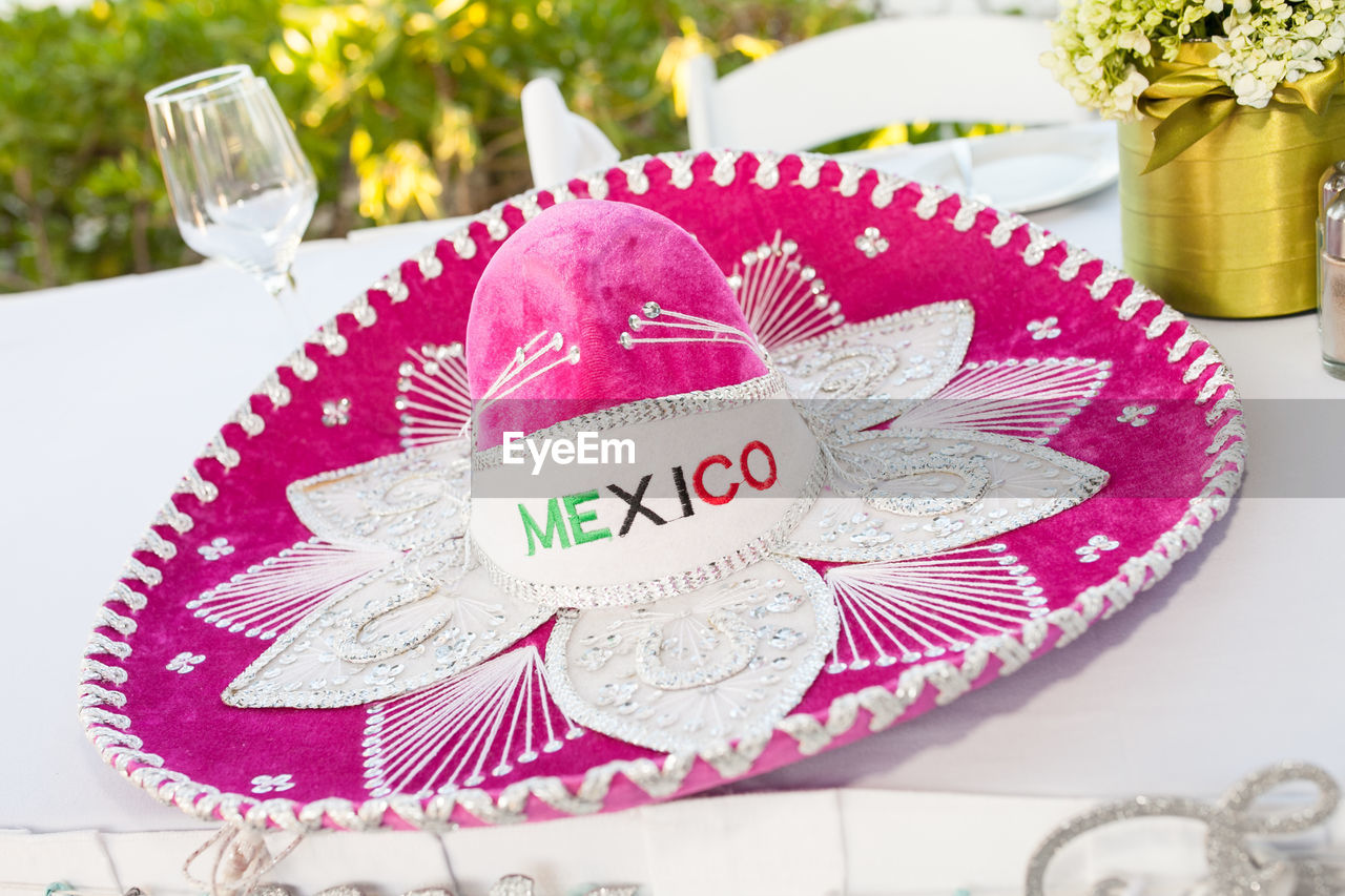 High angle view of sombrero with text on table during wedding