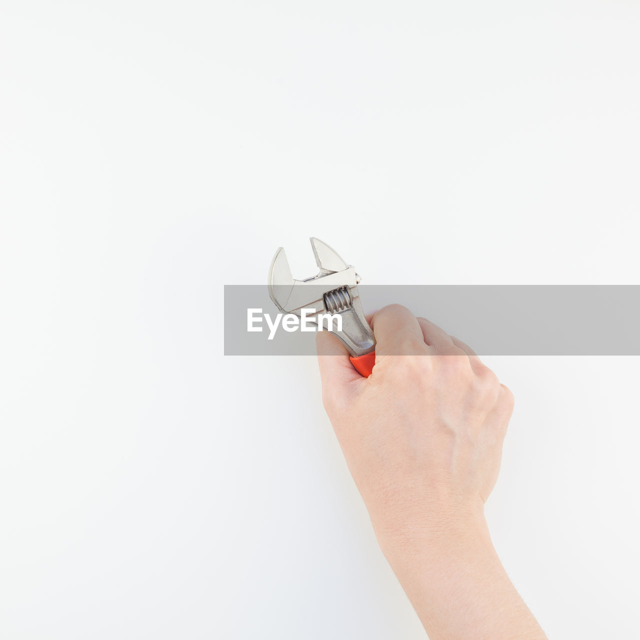 Close-up of hand holding work tool white background