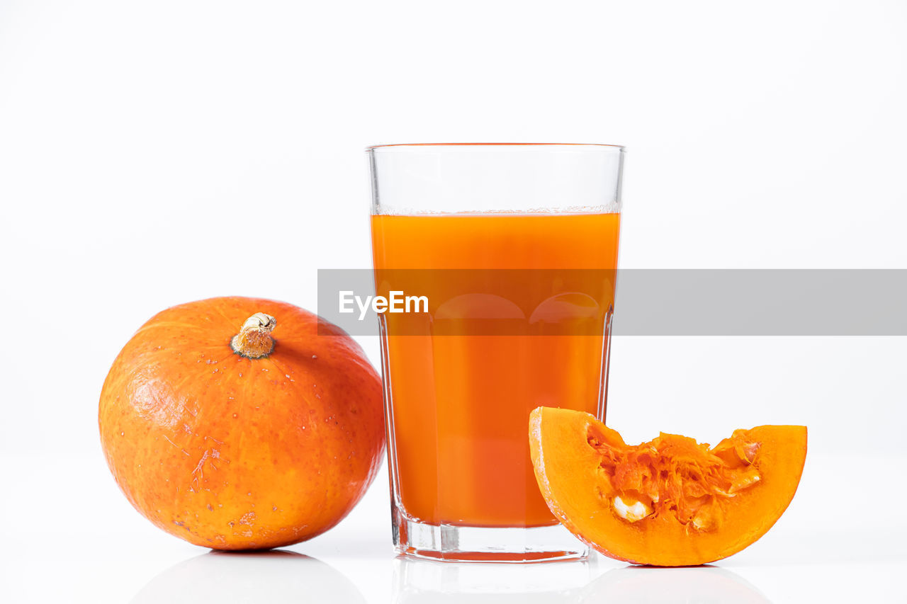 food and drink, orange color, orange, fruit, food, healthy eating, refreshment, drink, citrus fruit, drinking glass, household equipment, glass, juice, wellbeing, freshness, produce, soft drink, plant, white background, studio shot, no people, grapefruit, clementine, cut out, indoors, tangerine, still life, orange juice