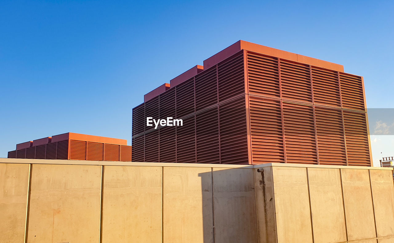 Low angle view of building against clear blue sky