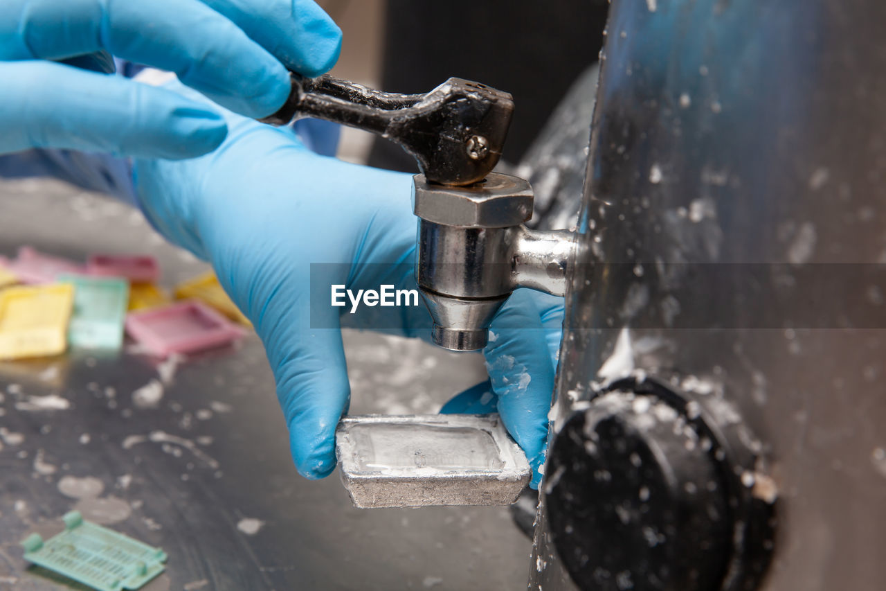 Scientist embedding tissues in paraffin blocks for sectioning. pathology laboratory. 