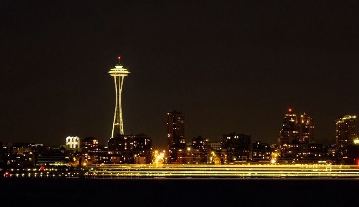 VIEW OF ILLUMINATED CITYSCAPE AT NIGHT