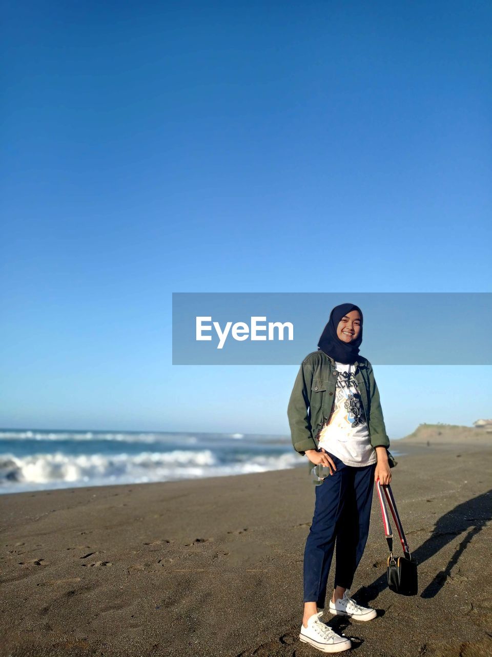 Full length of man on beach against clear sky