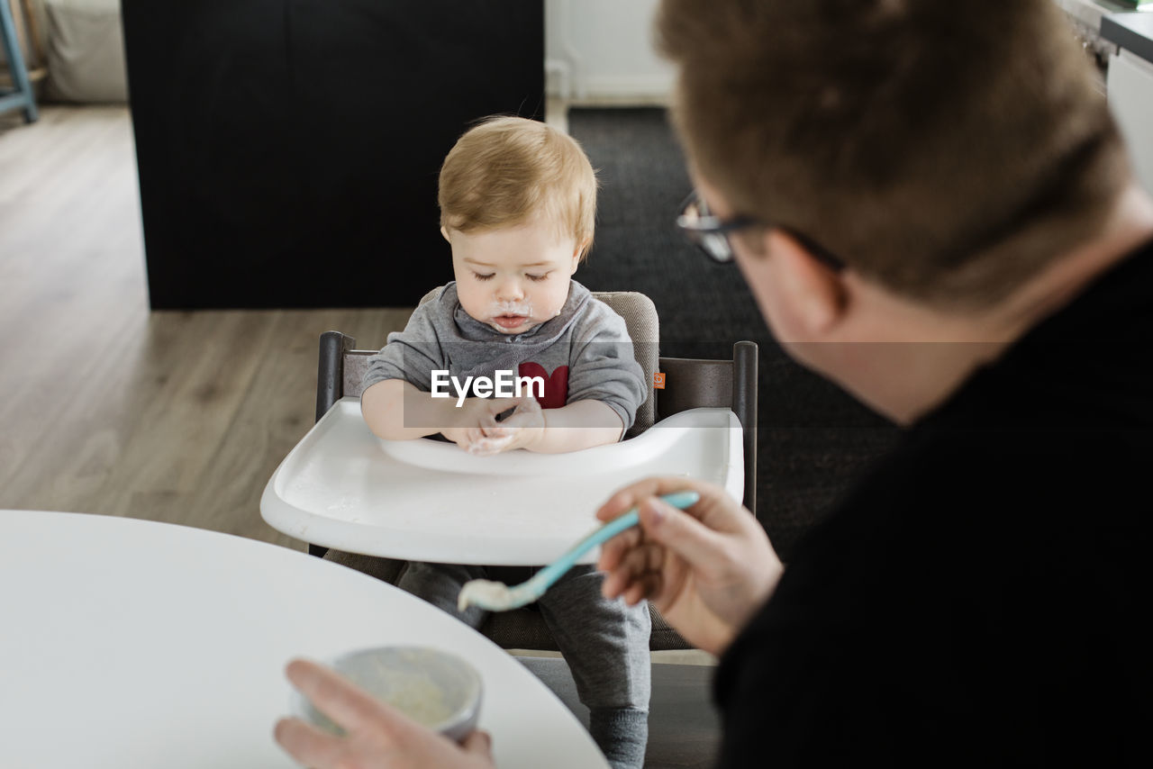 Father feeding baby boy