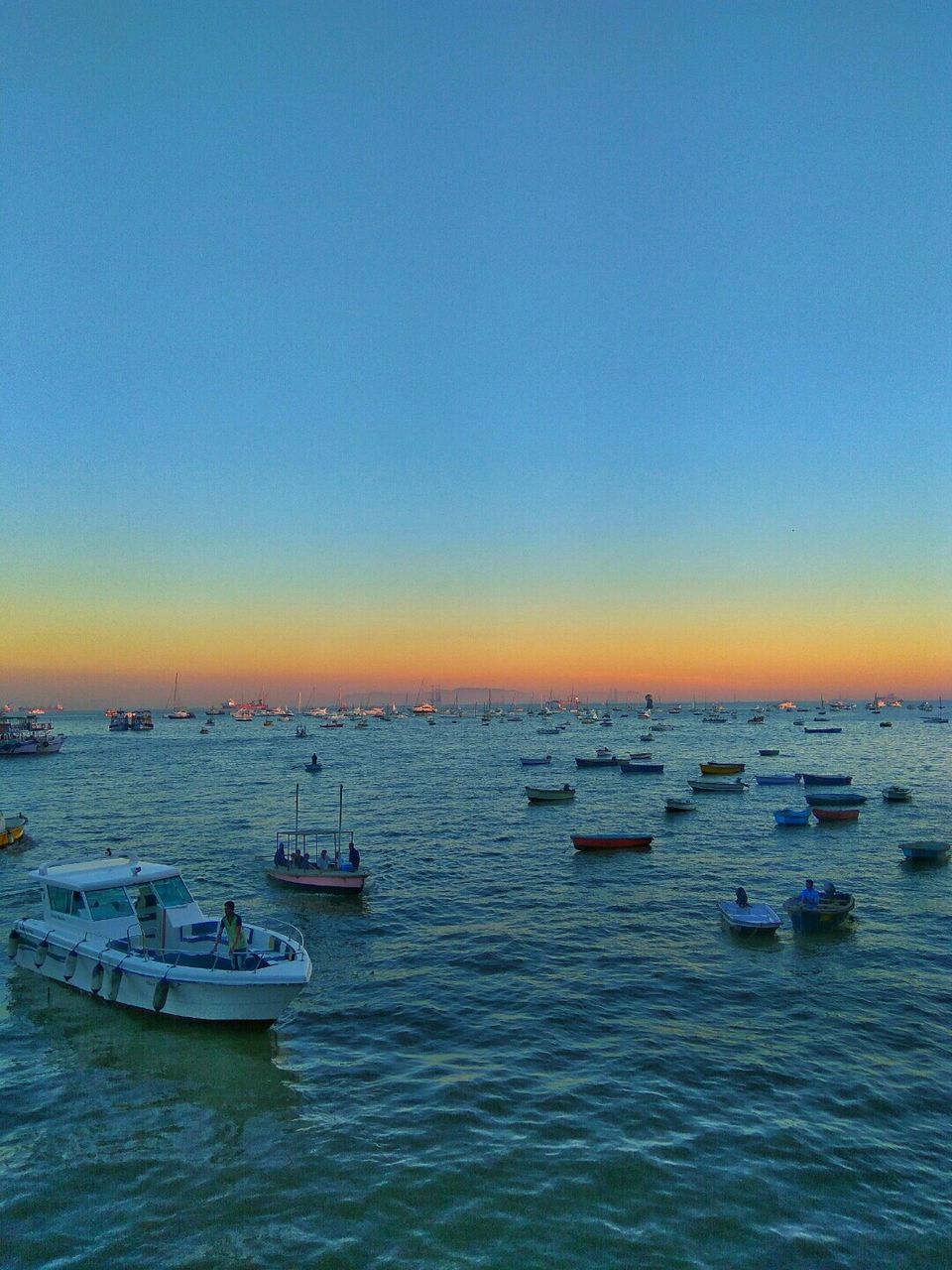 BOATS SAILING ON SEA AGAINST CLEAR SKY