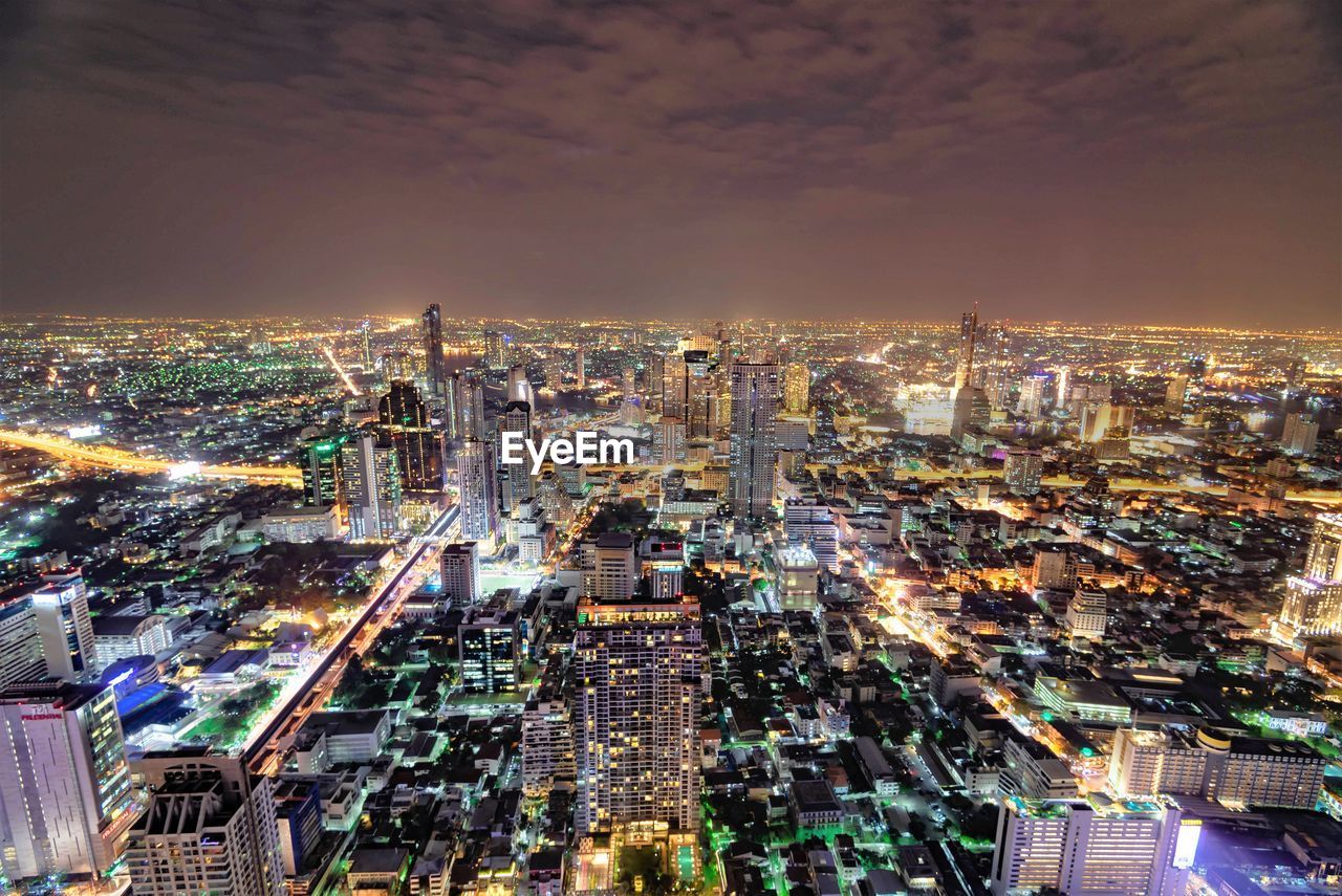 High angle view of illuminated buildings in city at night