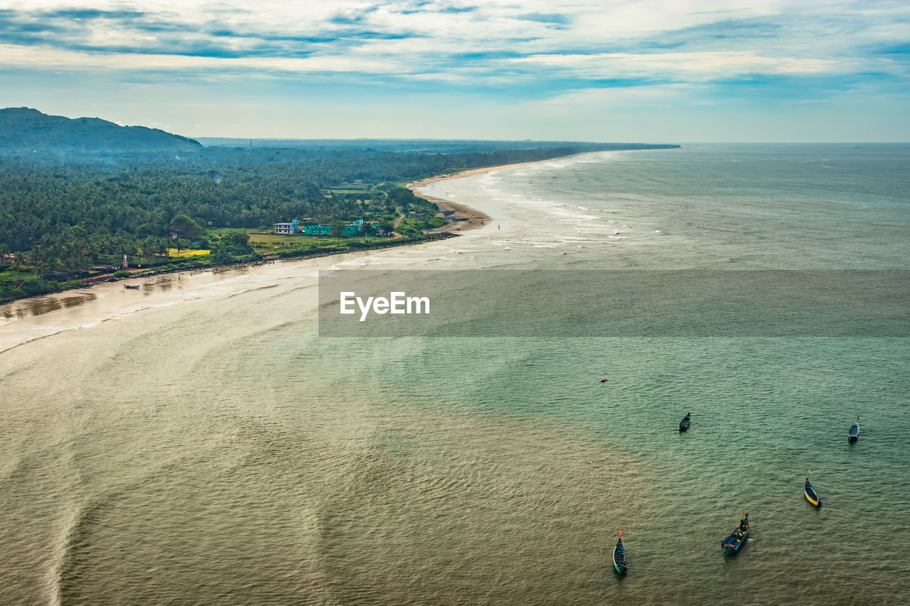 Beach isolated with fishing boats aerial shots with dramatic sky