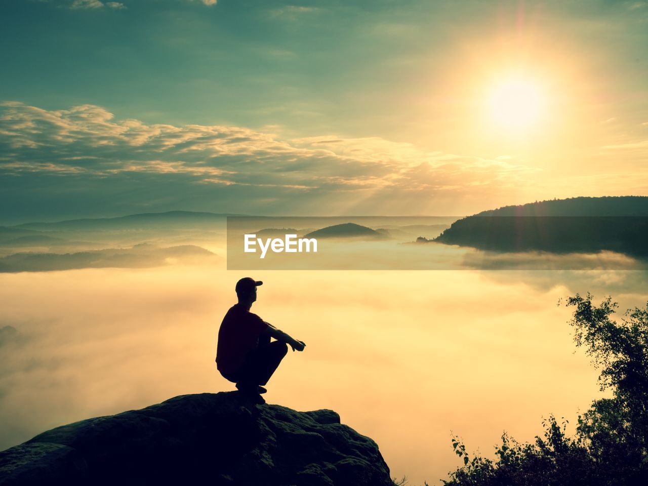 Moment of loneliness. man sit on rock.  sad person nature. fall mountain valley. tired man relaxing.