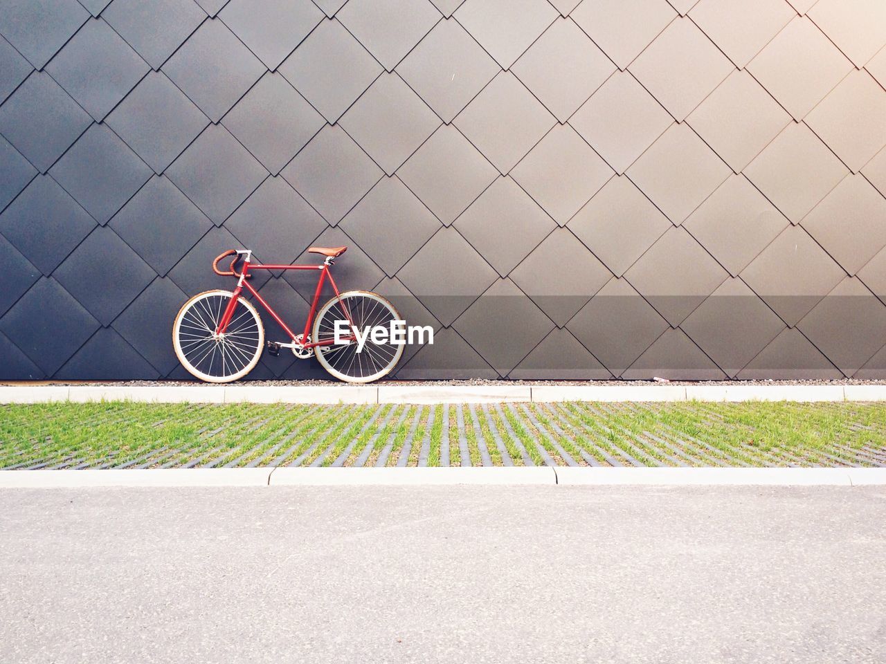 Bicycle parked against patterned wall