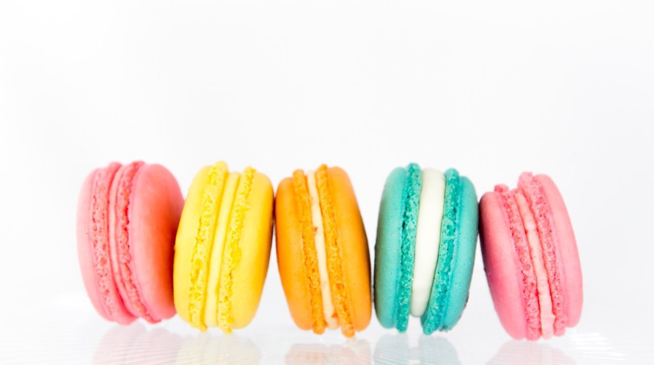 Colorful macroons against white background