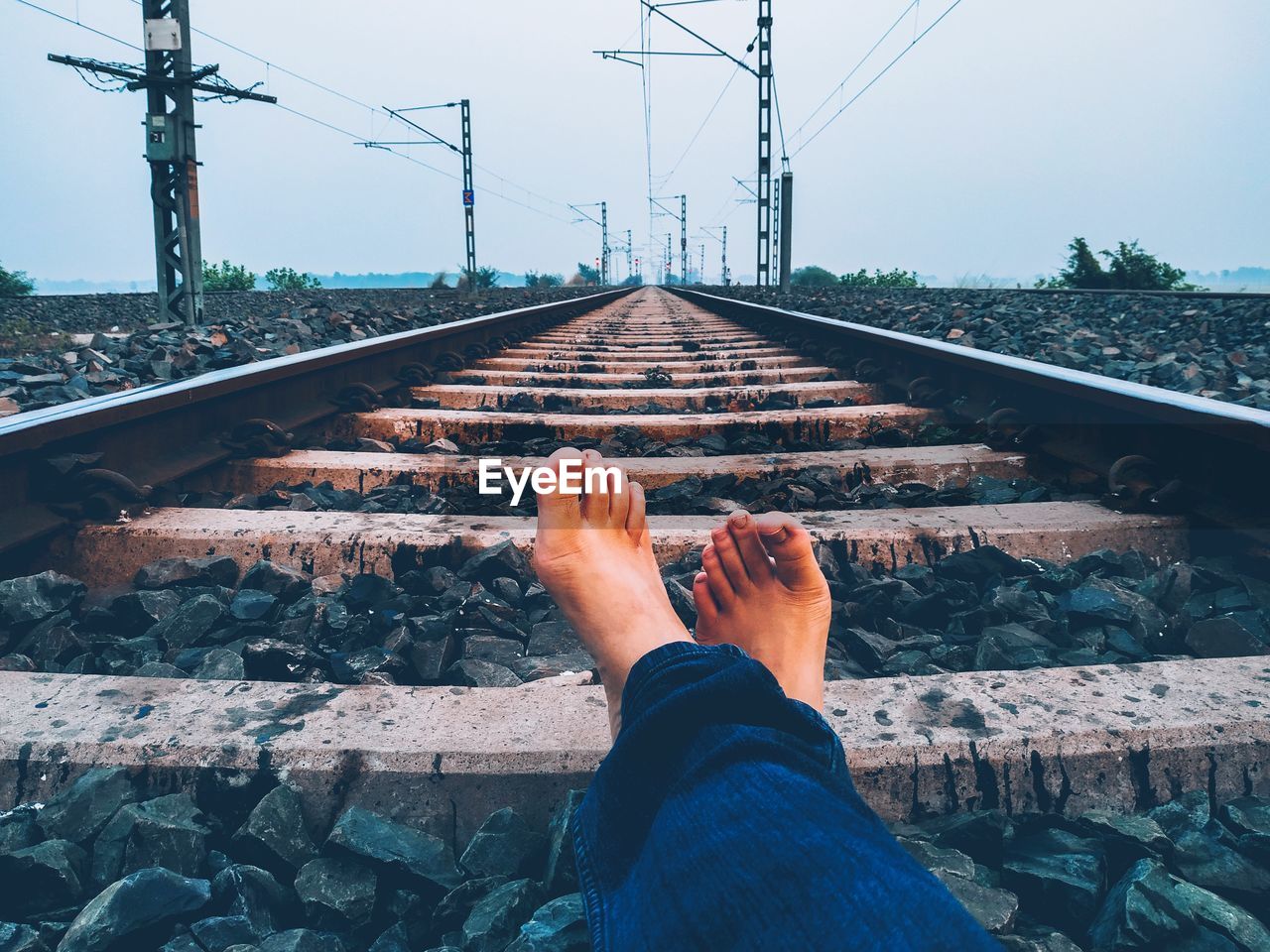 LOW SECTION OF MAN ON RAILROAD TRACKS