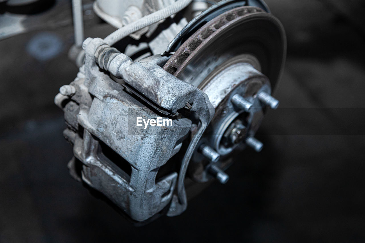 Close-up of a car hub, brake caliper, brake pads, brake disc, wheel bearing prepared for repair. 