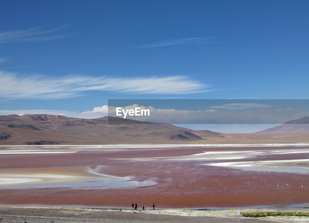 Scenic view of a pink lake against sky and mountains