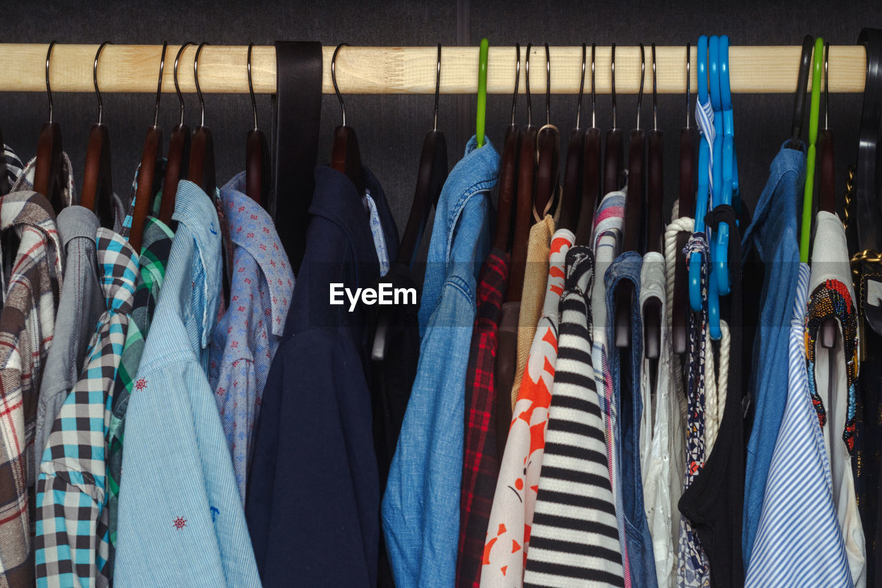 Men's and women's clothing on a hanger in the closet