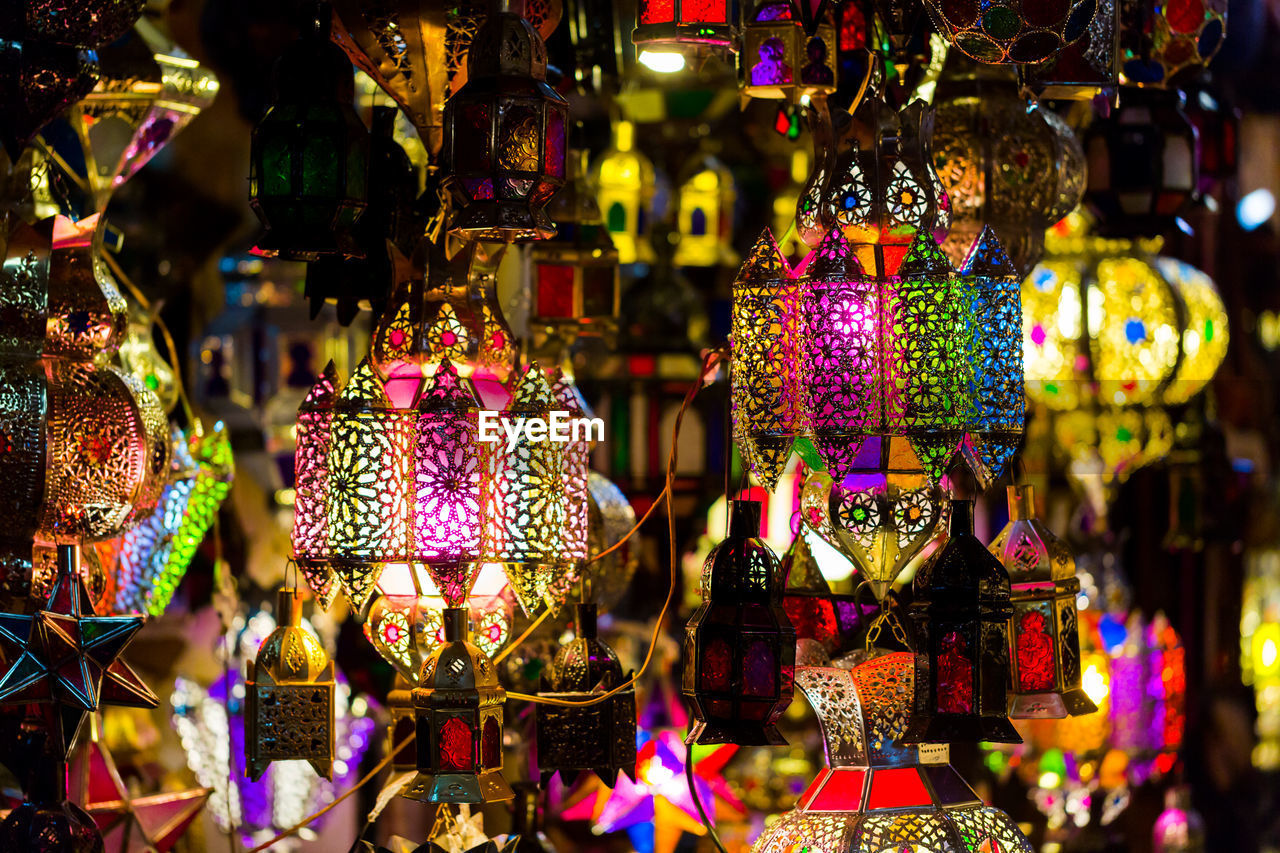 Illuminated lanterns hanging at market for sale during night