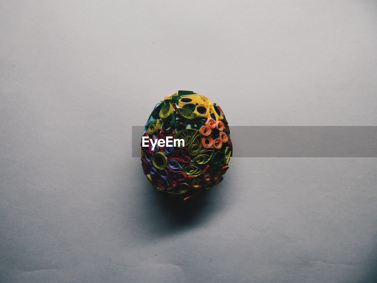 Close-up of colorful quilt paper ball on table