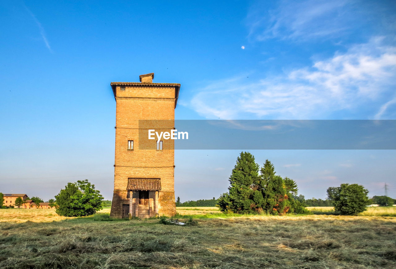 Built structure on field against sky