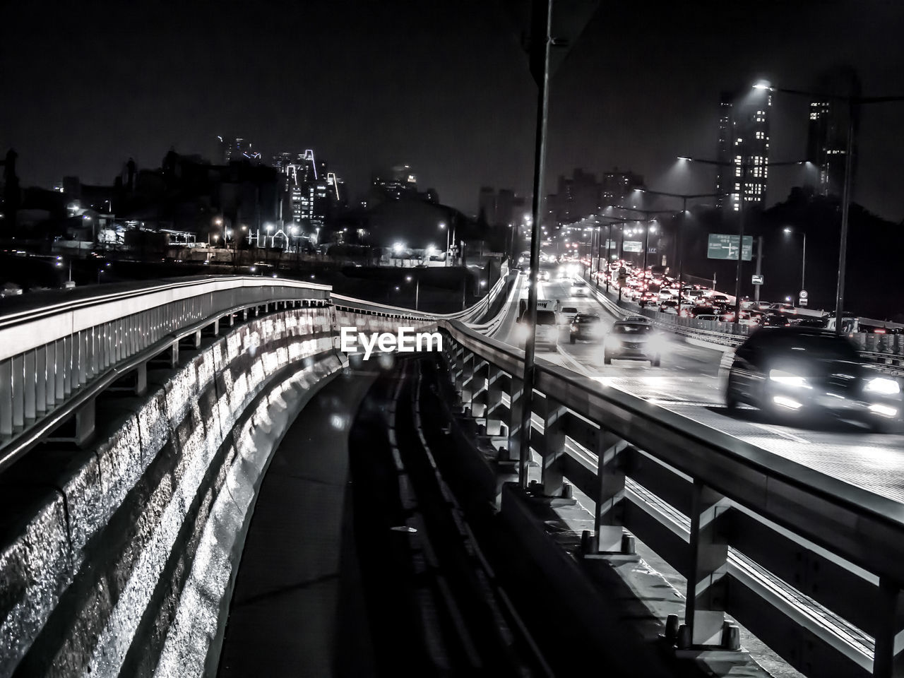 TRAFFIC LIGHT TRAILS ON BRIDGE IN CITY