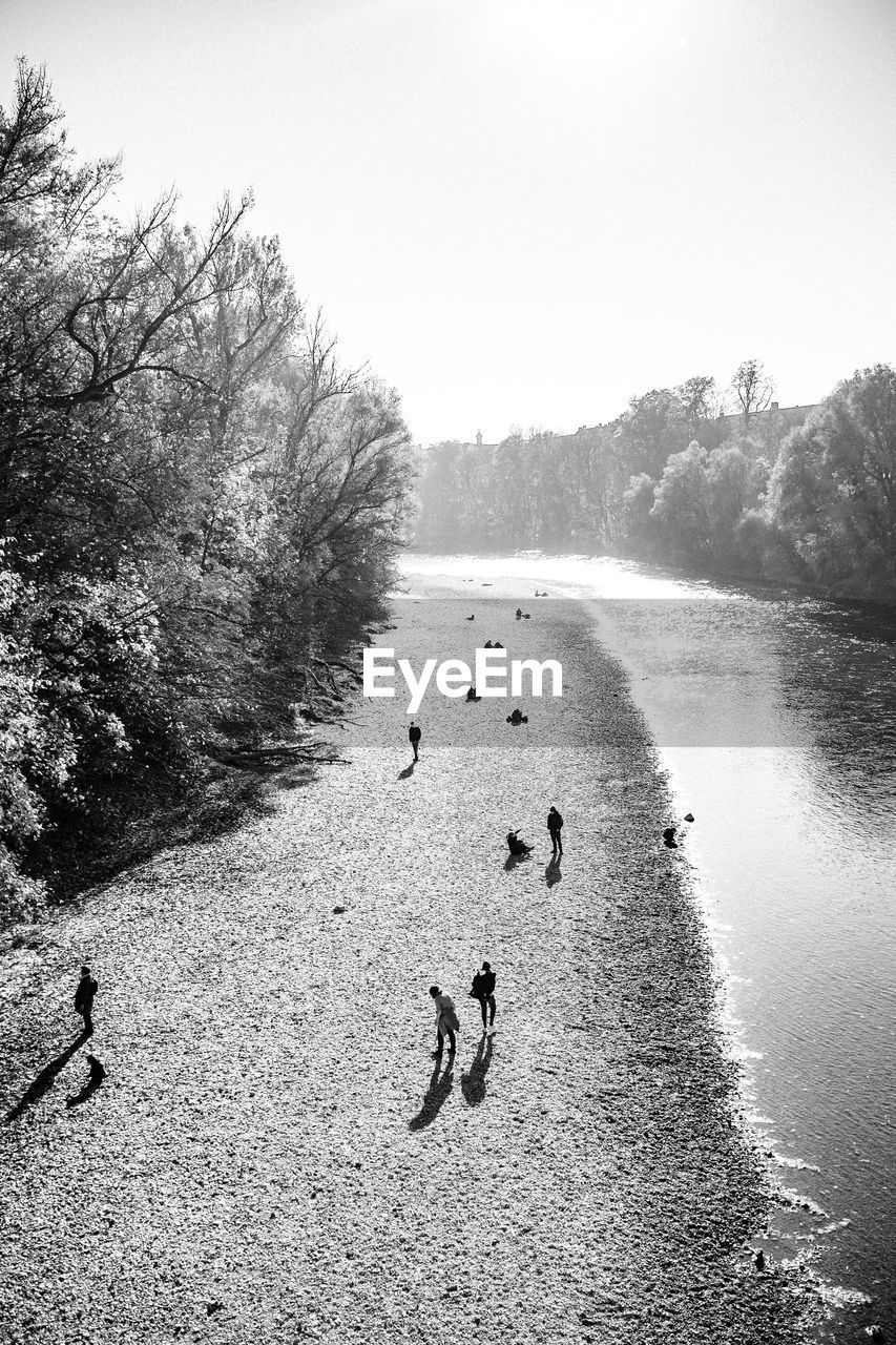 HIGH ANGLE VIEW OF PEOPLE ON SHORE AGAINST SKY